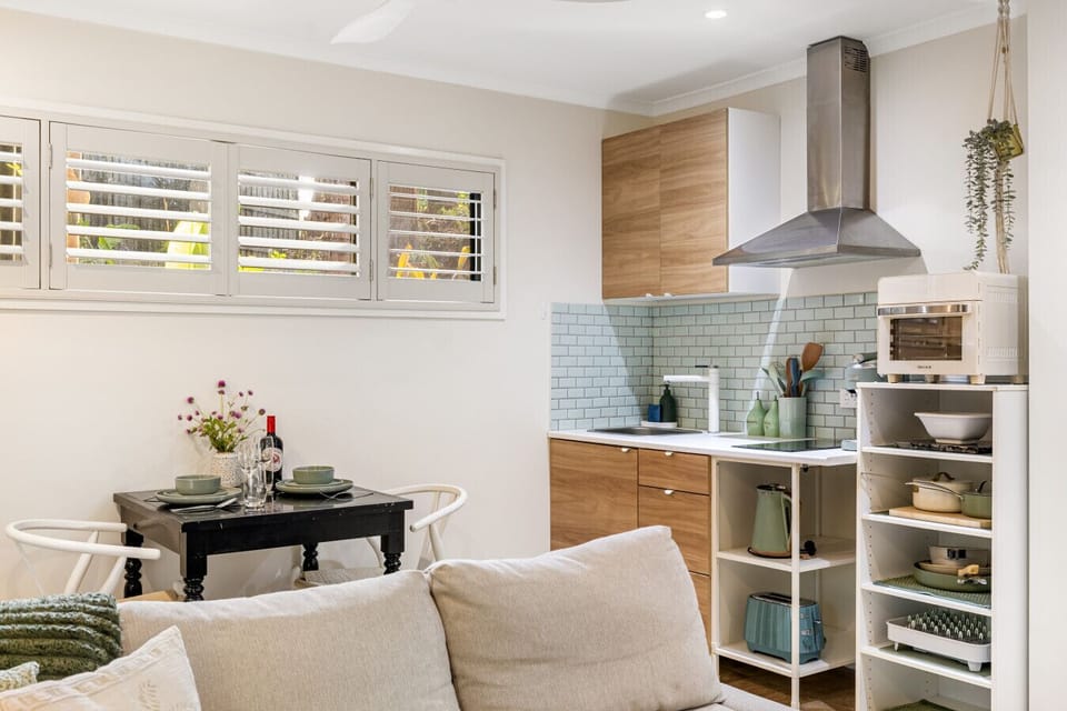 Open plan living, dining and kitchenette with balcony access