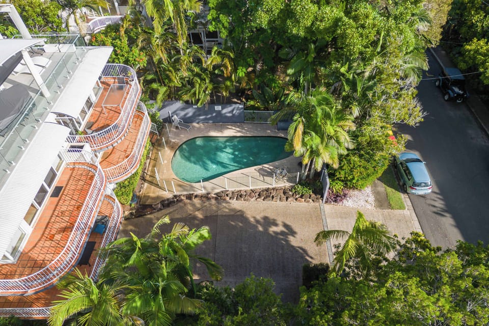 The complex boasts a sunny pool and lush, tropical gardens.
