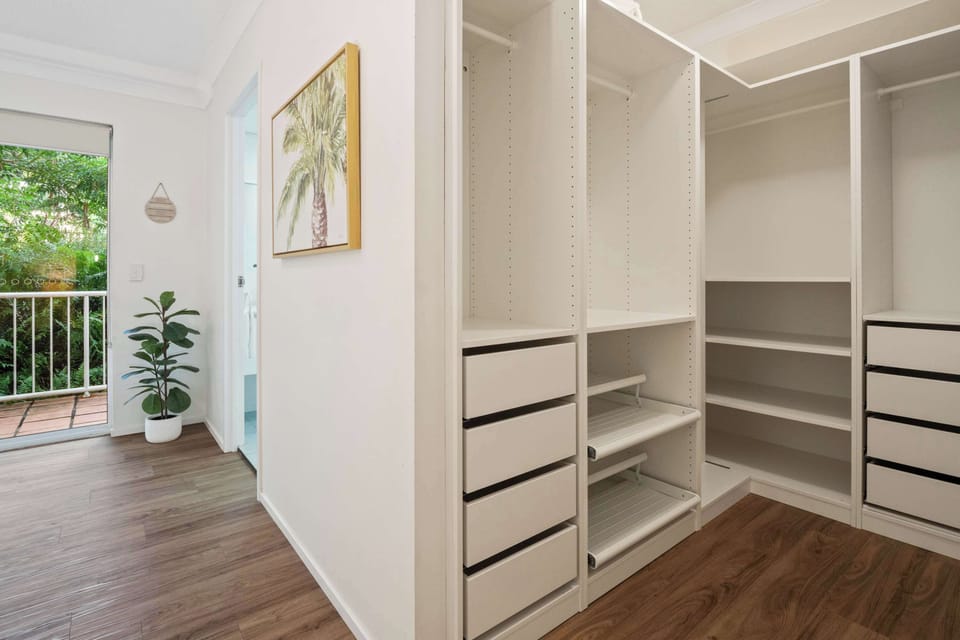 The walk-in robe offers plenty of space to unpack and feel instantly at home.