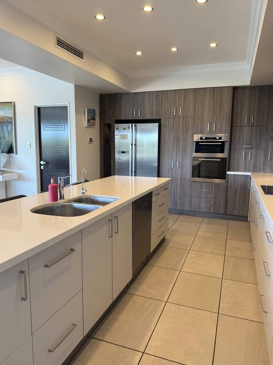 Bright, modern kitchen featuring expansive countertops, abundant cabinetry, and premium appliances for effortless cooking and entertaining.