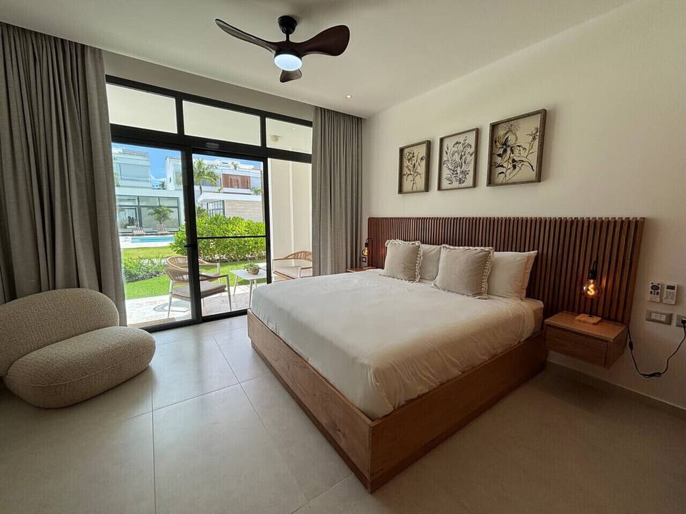 Master bedroom with a king bed and direct access to a private patio.