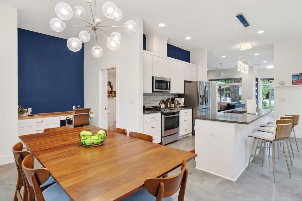 Bright dining area with backyard views, modern lighting, and direct access to the patio for effortless indoor-outdoor meals.