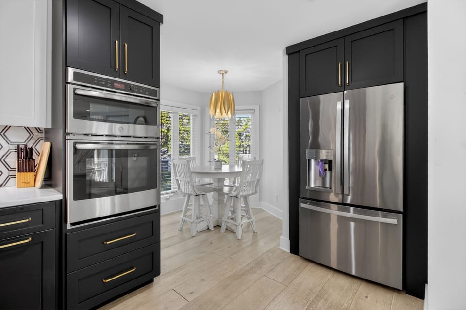 A view of the high-end stainless steel appliances and custom dark cabinetry.