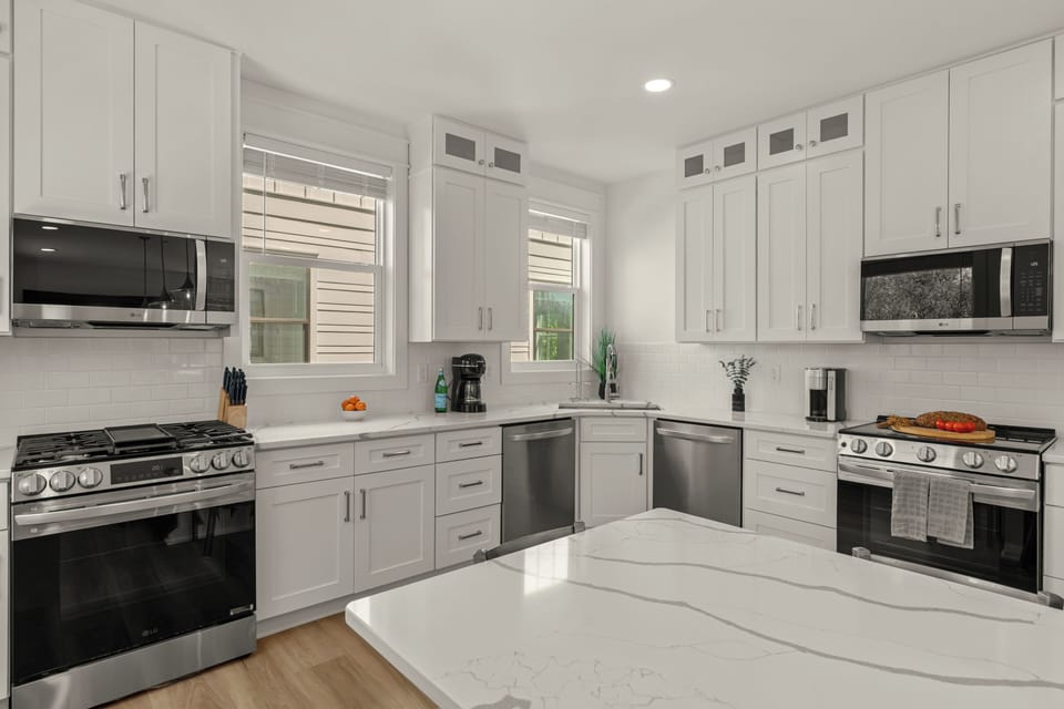 Modern kitchen with a large island and bar seating, perfect for group meals.