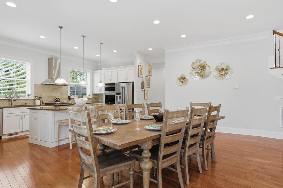 Bright dining area with a warm wood table.
