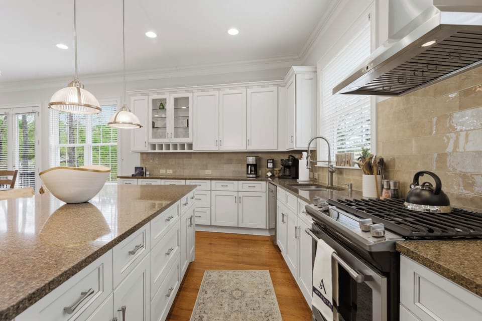 Bright modern kitchen with a spacious island, warm wood accents, and a clean, inviting layout.