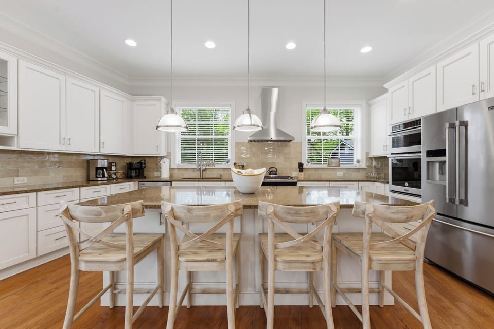 Bright, inviting kitchen with a spacious island, warm wood accents, and a clean modern flow.