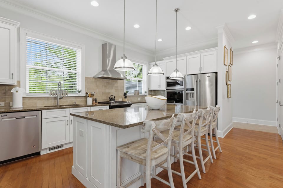 Bright modern kitchen with a spacious island, warm wood accents, and a clean, inviting layout.
