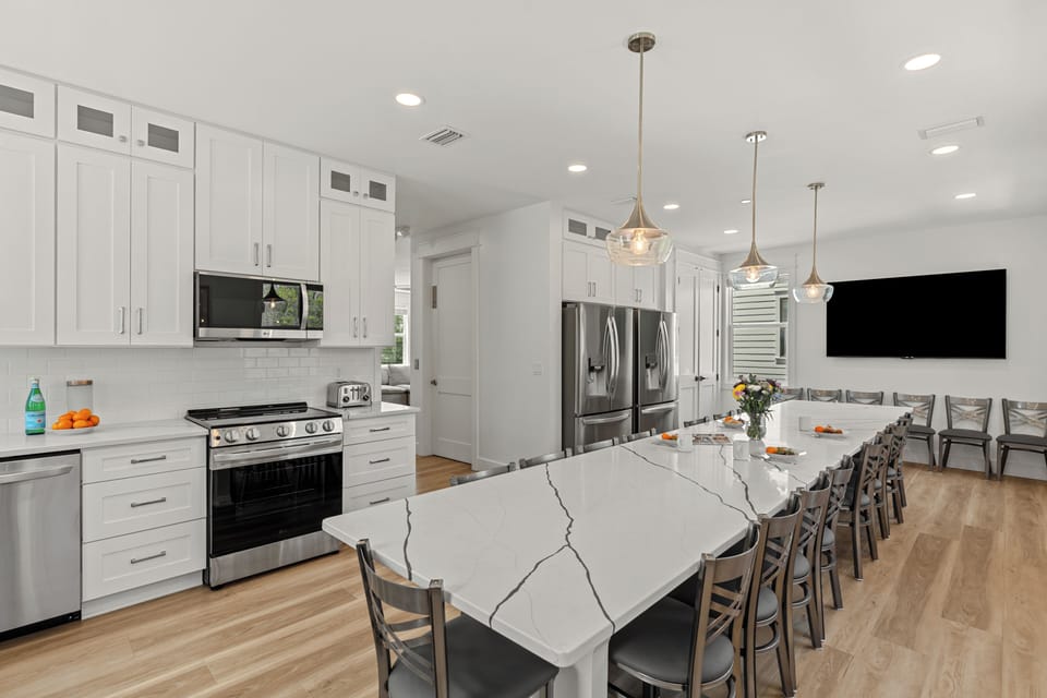 Modern kitchen with a large island and bar seating, perfect for group meals.