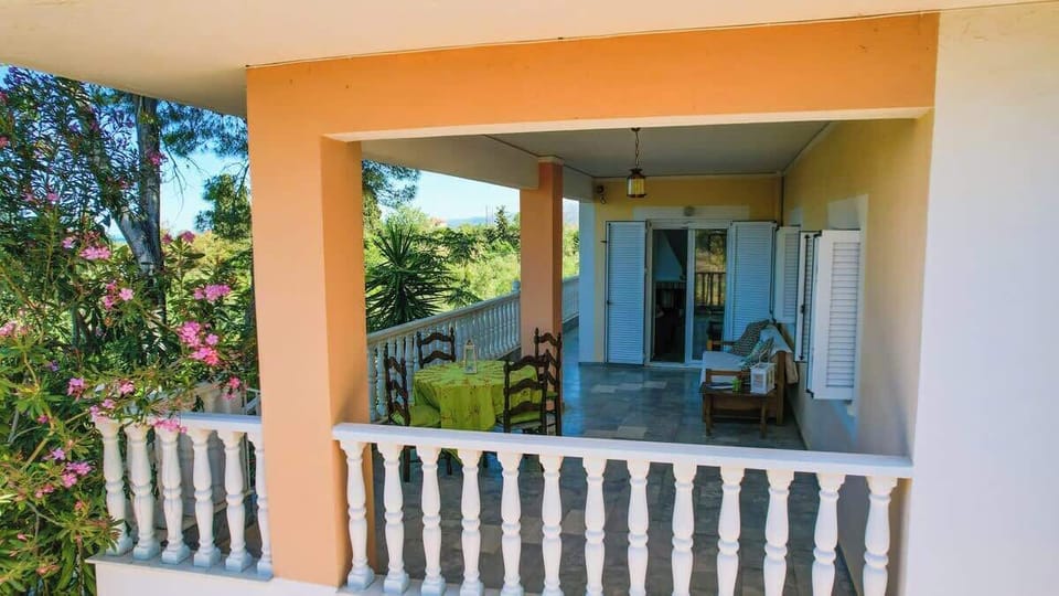 Spacious covered veranda with comfortable seating, perfect for relaxing in the shade at any time of day.