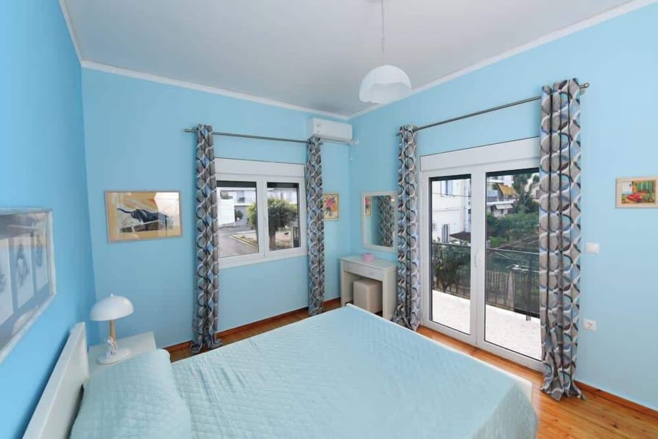 First bedroom filled with natural light and access to a balcony.