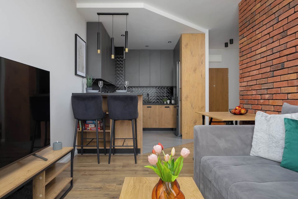 The kitchen island features high bar stools, making it a perfect spot for quick meals or morning coffee.