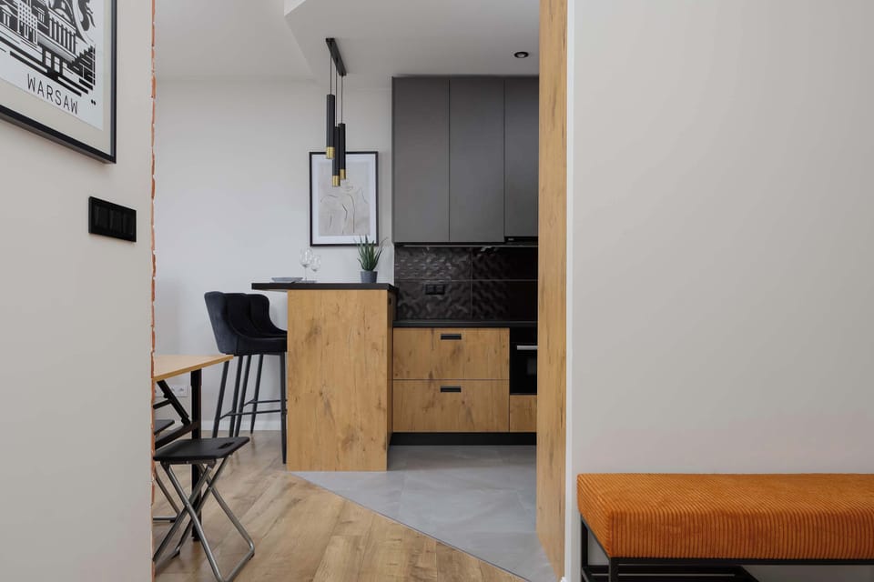 A view from the hallway looks into the kitchenette, showcasing the open-plan layout of the modern apartment.