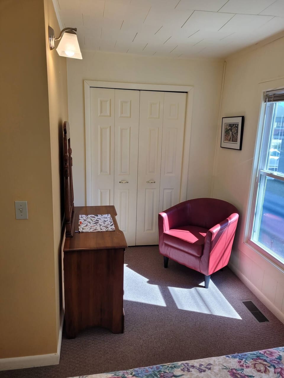 BEDROOM #1:  Features a queen-size bed, dresser, closet, and chair.