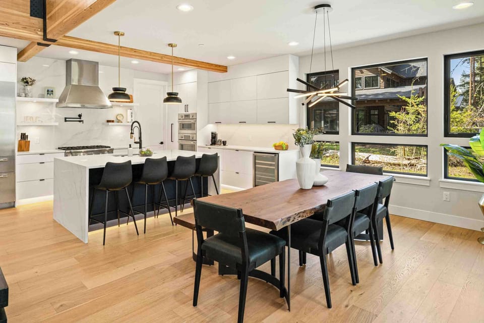 The live-edge dining table and marble island make this space feel like it was designed for groups who love to eat well