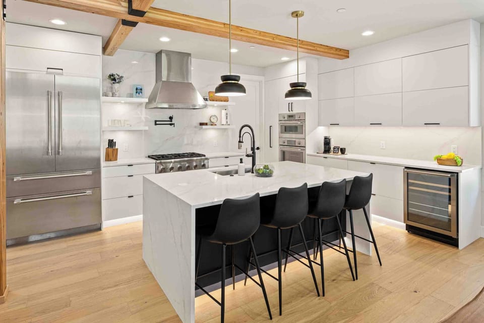 The marble island seats four and keeps the cook connected to everyone in the living room