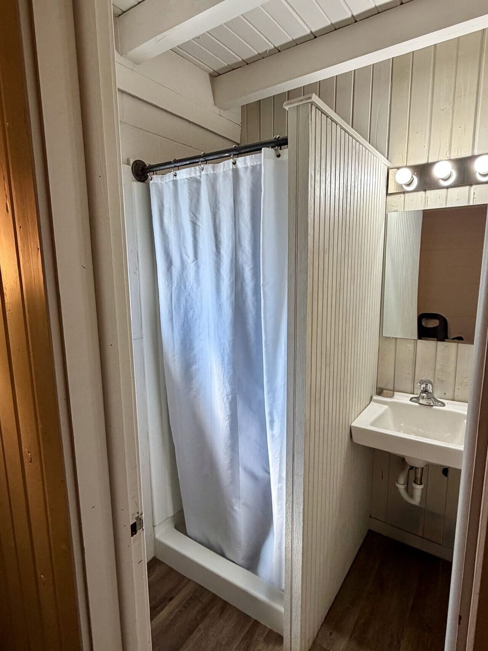 Private bathroom with shower, vanity sink, and mirror in The Vinyl Lounge at The Cedar