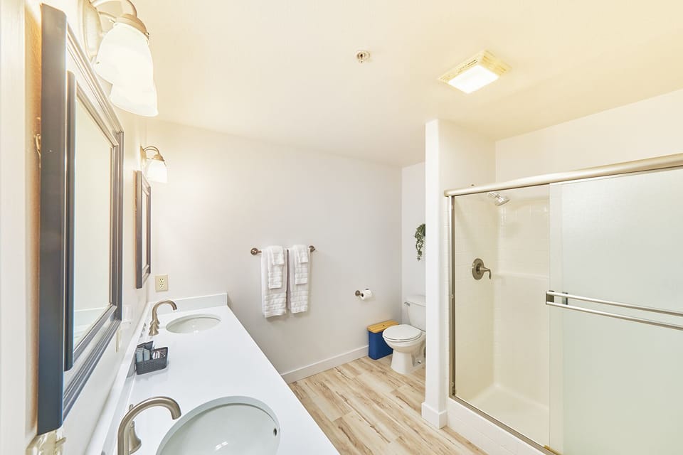 Bathroom with double vanity and shower