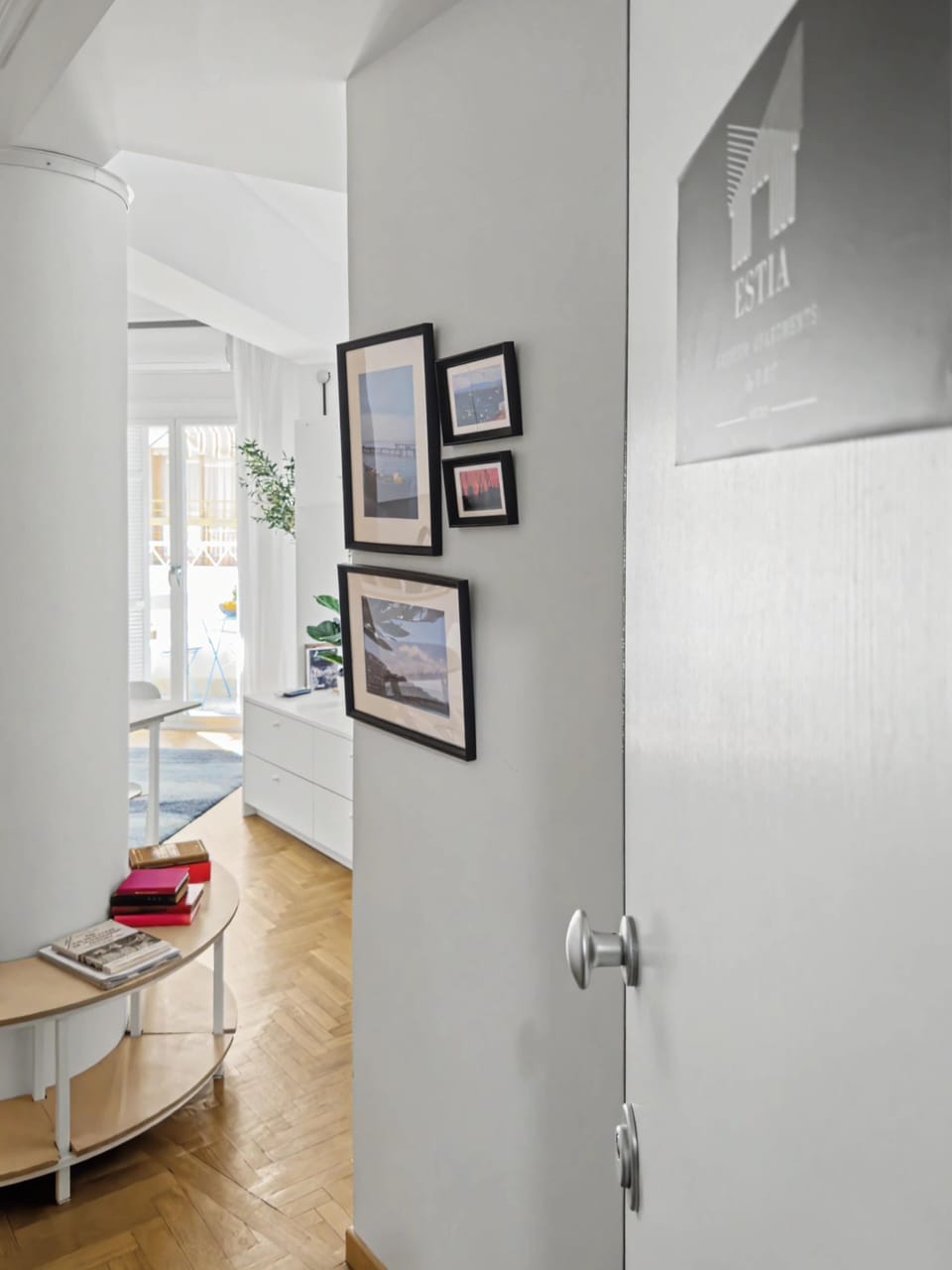 Bright hallway view connecting the living spaces, featuring elegant decor and natural light. The clean design and warm tones create a welcoming atmosphere, offering a smooth flow between rooms with a sense of understated luxury.