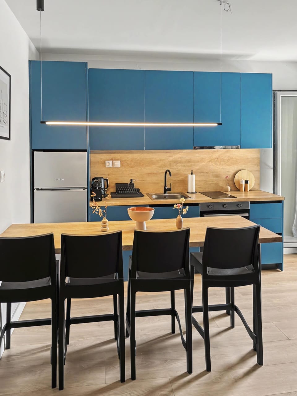 Dining room
Dine with friends in a dedicated space. Features a contemporary wood table, sleek chairs, unique wall art, and warm pendant lighting.