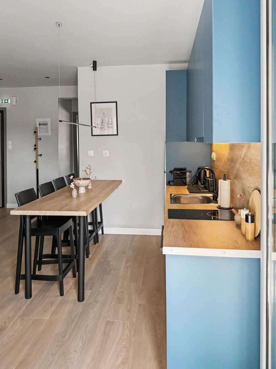 Kitchen 1
Prepare gourmet meals in the fully equipped, L-shaped kitchen. Modern blue and wood cabinetry, premium appliances, and a handy breakfast bar.