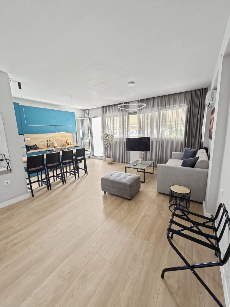 Living room
A bright, open-concept living and dining layout featuring warm wooden floors, contemporary furniture, and a stylish urban design.