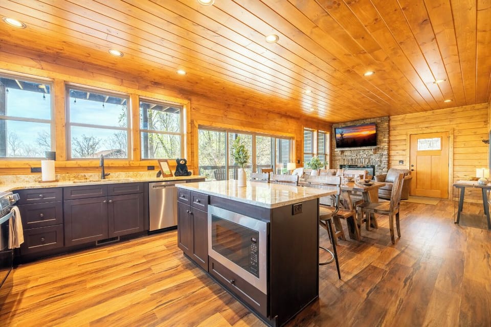 Cook together in your open kitchen with stunning wood beam ceilings and panoramic windows bringing nature indoors.