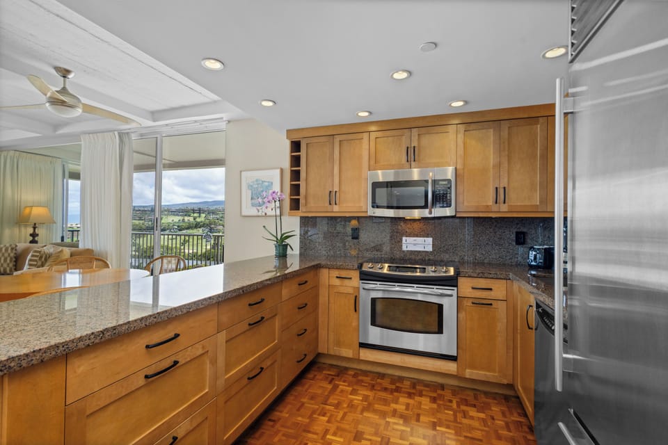 Your fully equipped kitchen features granite counters, stainless appliances, and stunning views while you cook and dine.