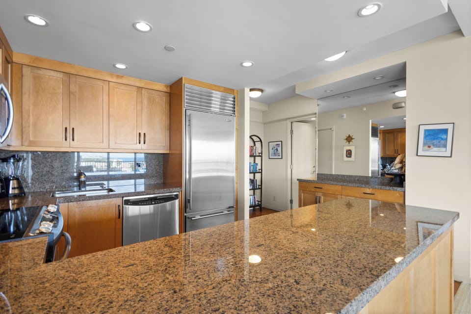 Your fully equipped gourmet kitchen features granite counters, stainless appliances, and ample space for cooking memorable meals together.