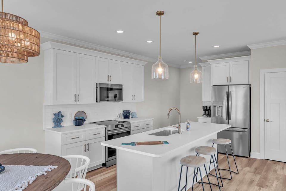 Your fully equipped kitchen features stainless steel appliances, quartz countertops, and a breakfast bar perfect for morning coffee or meal prep.