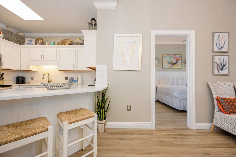 Gather family around the cozy bar stools to chat and unwind in this inviting kitchen space