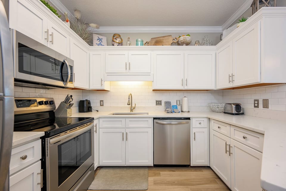 Craft delicious meals while enjoying the inviting layout and warm charm of this beachside kitchen