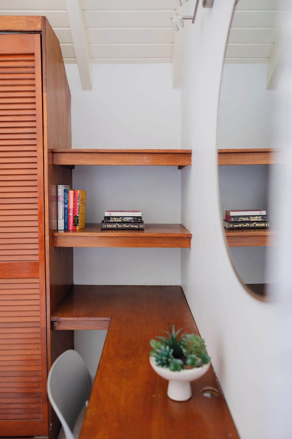 Master bedroom workspace with desk and built-in shelving.