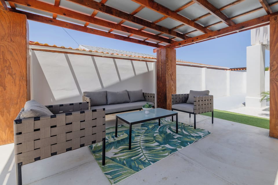Shaded outdoor lounge, breezy and relaxed.