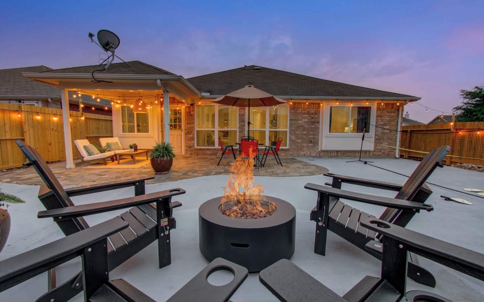 Cozy fire pit lounge under string lights—perfect for evening chats, s’mores, and backyard vibes.