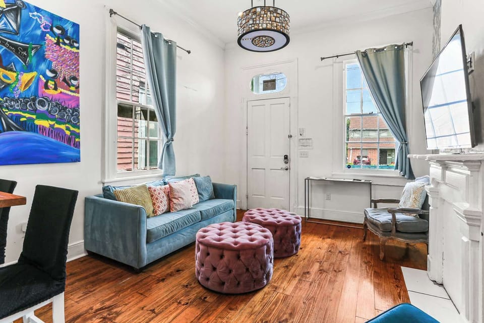 Sun-filled living area with large windows, inviting seating, and a warm, welcoming atmosphere for your group.