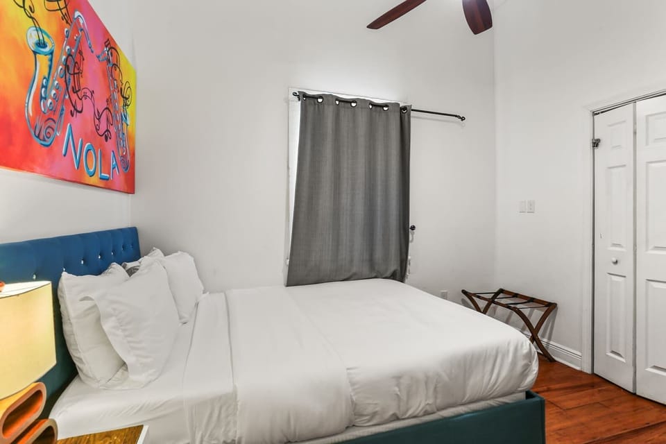 Bright and comfortable bedroom with colorful artwork, soft linens, and a relaxed vibe for a restful stay.