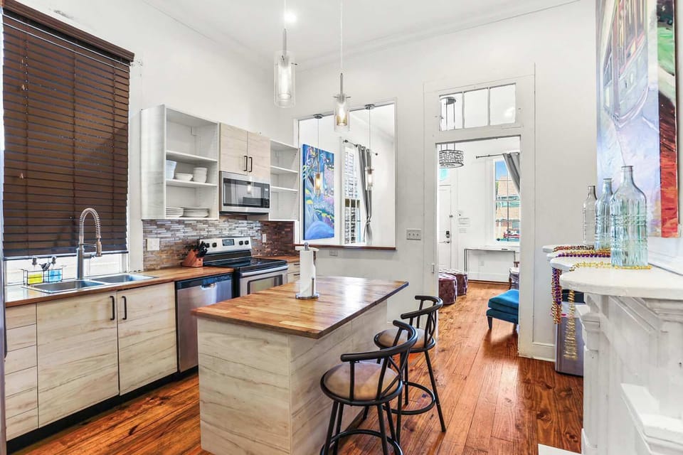 Another angle of the open kitchen highlighting the island workspace and easy flow into the living area.