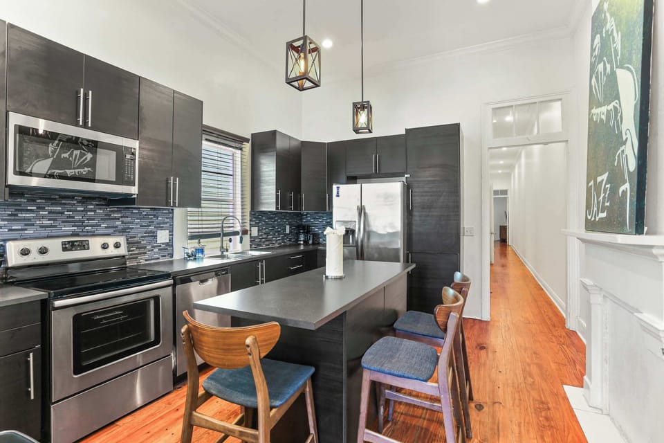 Modern kitchen with sleek finishes, stainless steel appliances, and bar seating for casual meals or morning coffee.