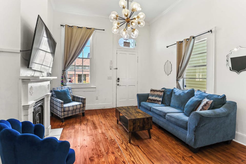 Another view of the living area showcasing tall ceilings, natural light, and comfortable seating for your group.