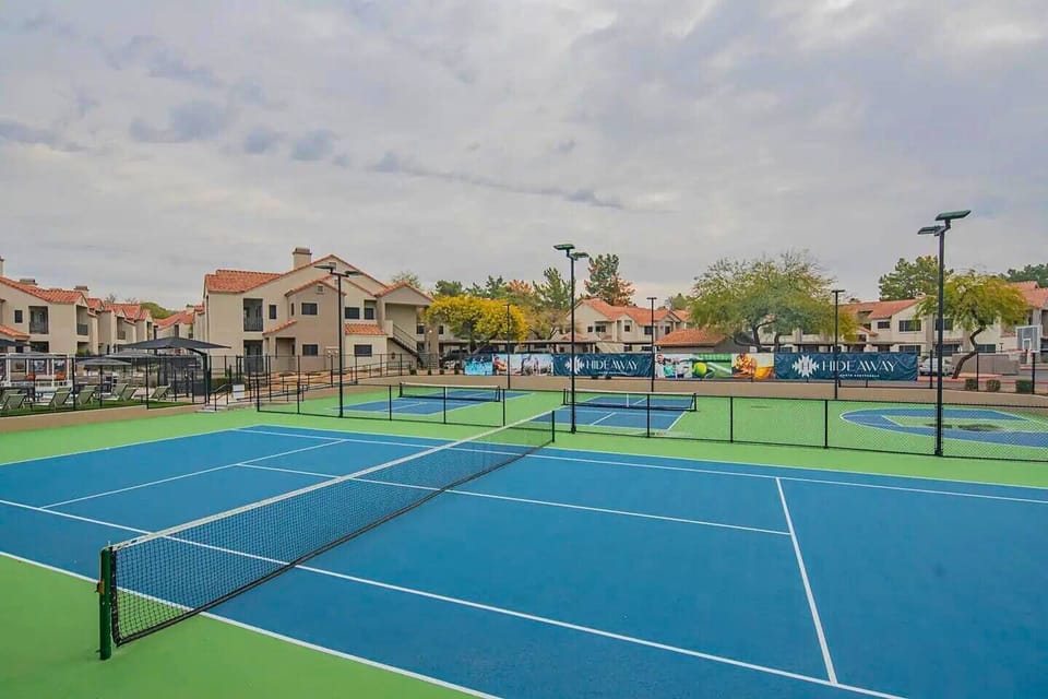 Enjoy a match on this wide-open tennis court, perfect for a sunny day!