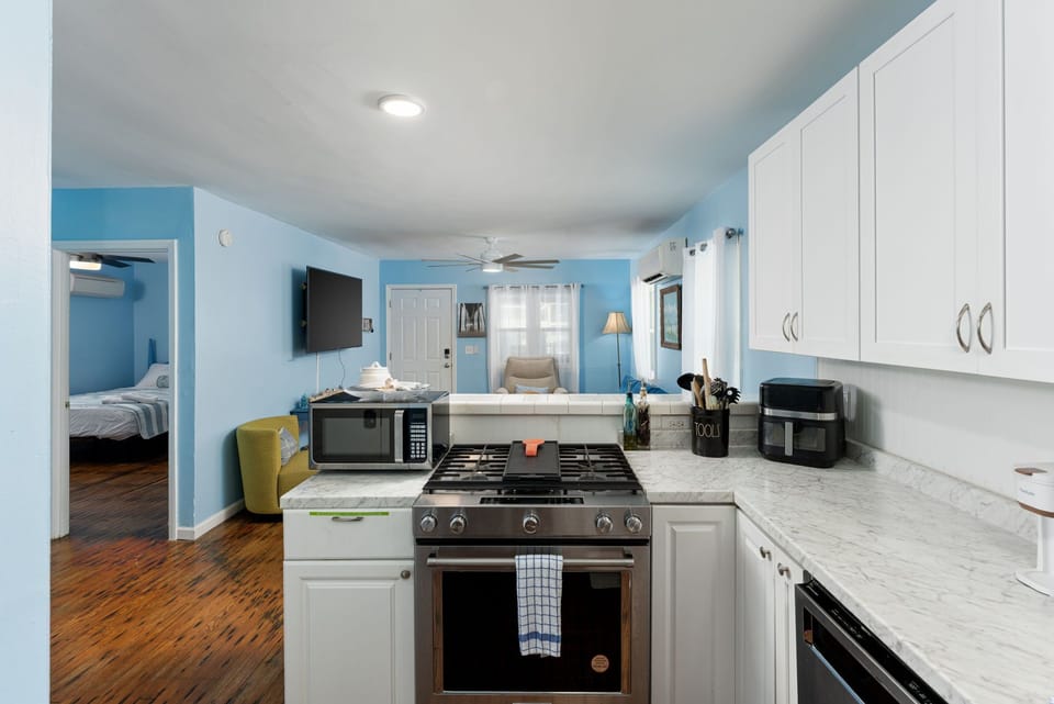 Your bright, welcoming kitchen opens to cozy living and bedroom spaces, with modern appliances and ample storage ready for your vacation meals and relaxation.