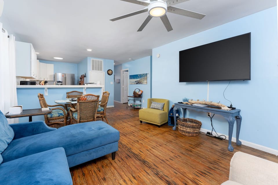 Relax in your spacious coastal retreat with soothing blue tones and charming wicker seating. Enjoy beachy décor, a large TV, and an open-concept dining area perfect for memorable meals together.