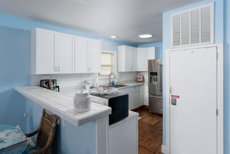 Your bright, coastal-inspired kitchen awaits with all the essentials for creating memorable meals. The airy space features ample counter space and modern appliances to make cooking feel effortless.