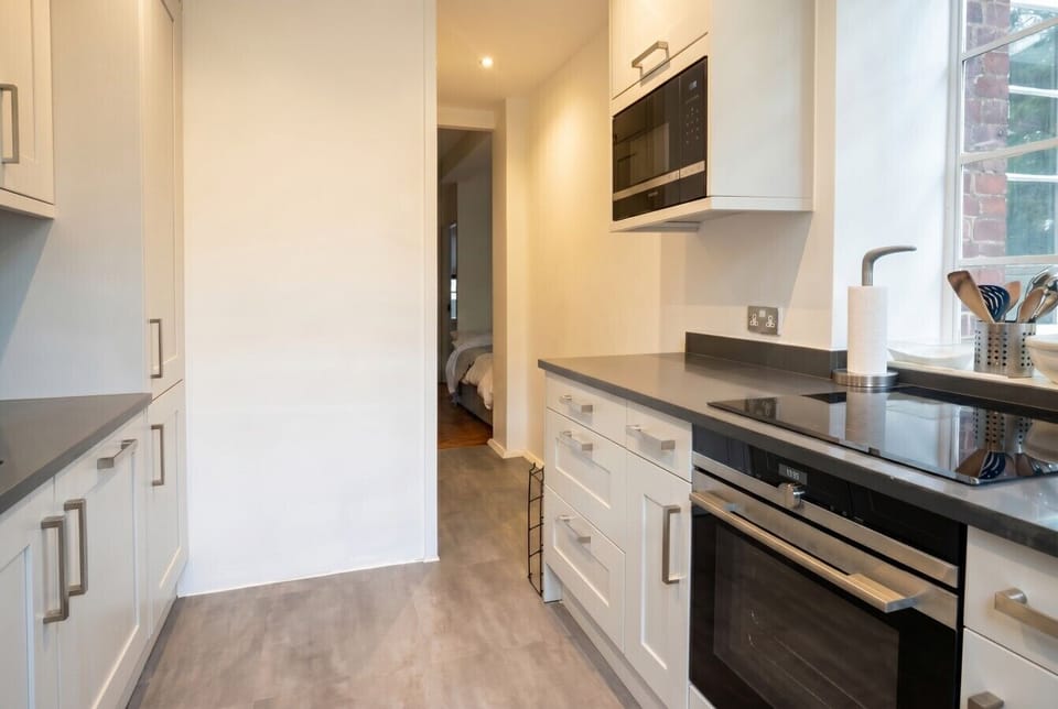 Modern kitchen with induction hob, built-in oven, and plenty of storage space.