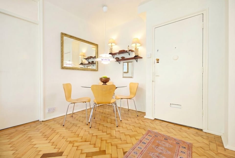 Bright dining nook on warm parquet floors, perfect for relaxed meals together.