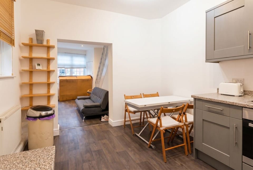 The dining table seats four and opens straight through to the living room beyond.