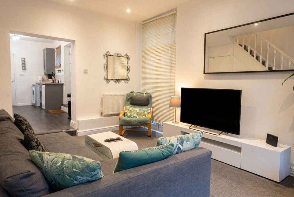 A flat-screen TV, armchair, and corner sofa give you real room to switch off.
