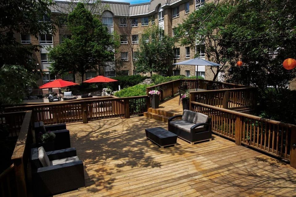 Landscaped courtyard with lounge seating — step outside for fresh air without leaving the property.