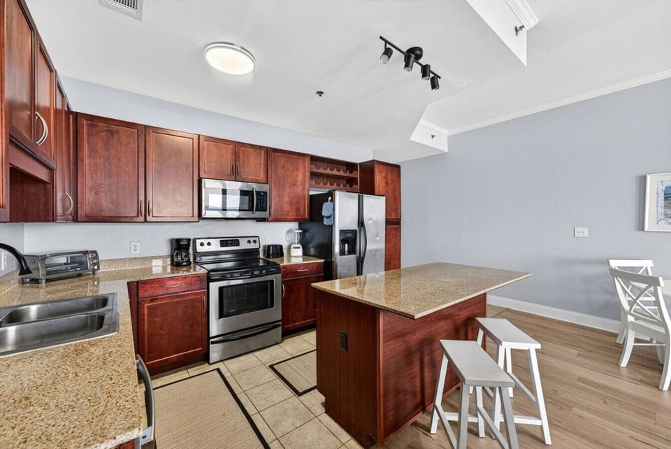 Fully equipped kitchen with granite countertops and stainless steel appliances.